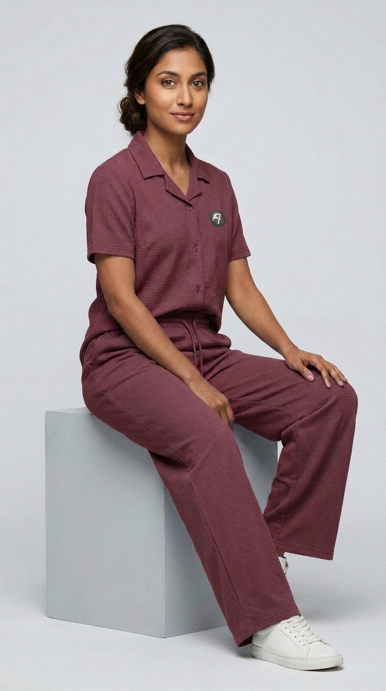 AT7X Berry Mauve sleepwear co-ord set, seated view showing relaxed fit and jacquard interlock fabric