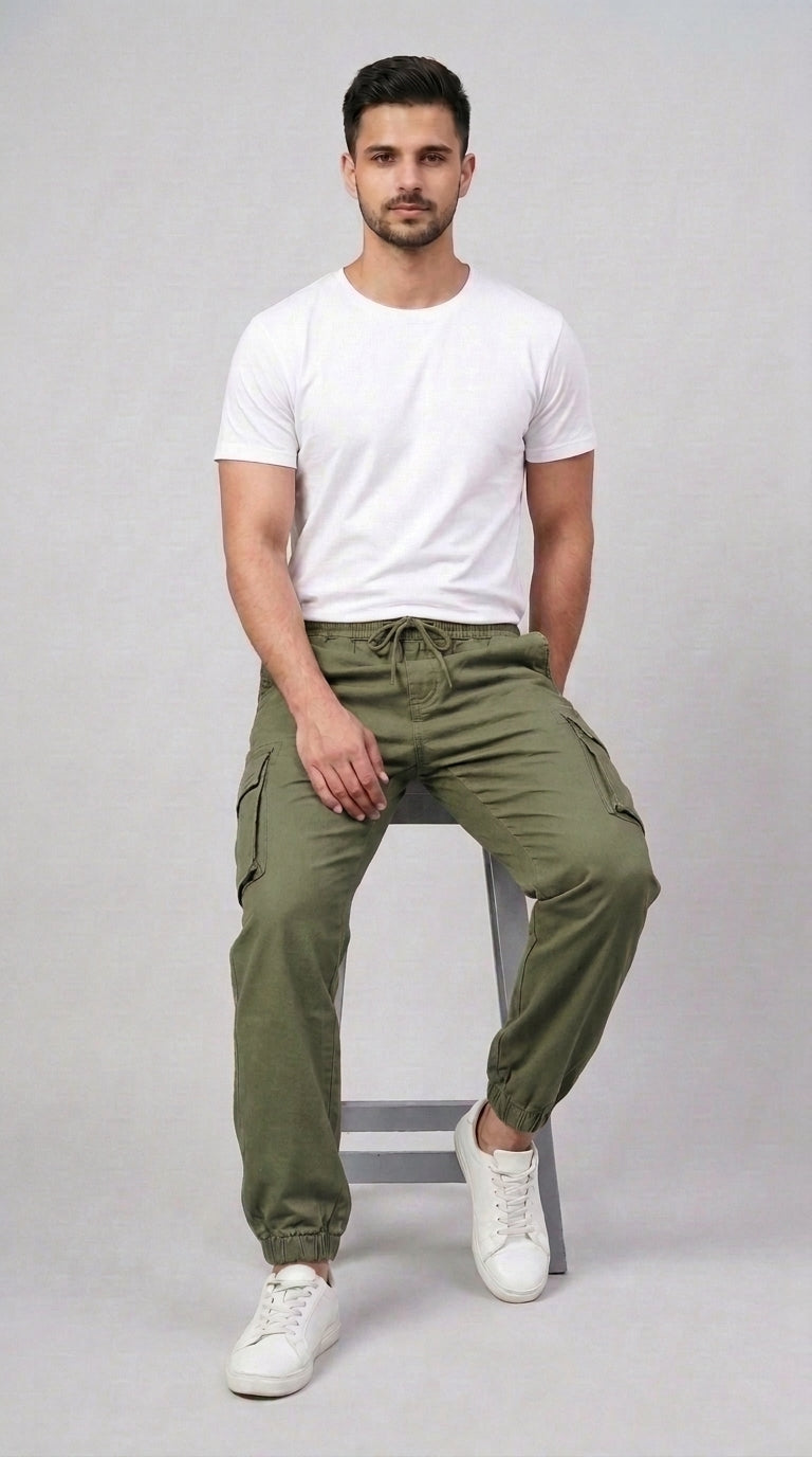 AT7X Classic Olive Green 5 pocket loose fit jogger trouser for men, seated view showing loose fit and gathered ankle cuff
