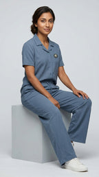 AT7X Steel Blue sleepwear co-ord set, seated view showing relaxed fit and jacquard interlock fabric