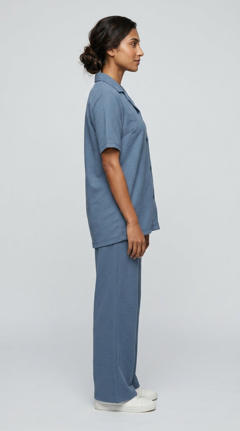 AT7X Steel Blue sleepwear co-ord set, side view showing loose wide leg trouser and shirt hem